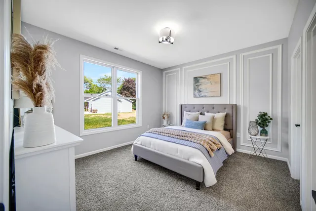 a spacious bedroom with a bed and a window