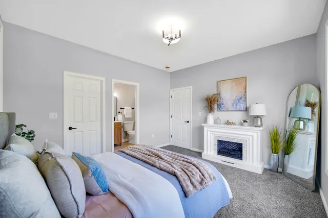 a spacious bedroom with a bed and a chandelier