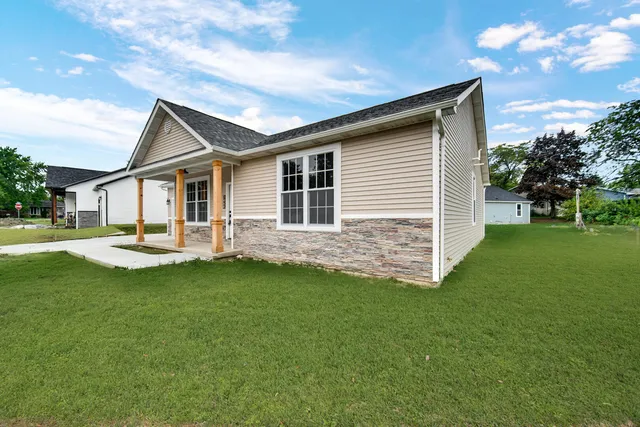 a front view of house with yard and green space