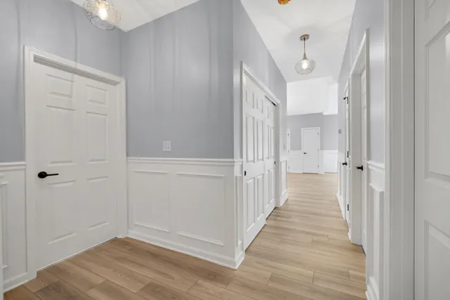 a view of a hallway with wooden floor