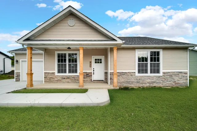 a front view of a house with a yard and porch