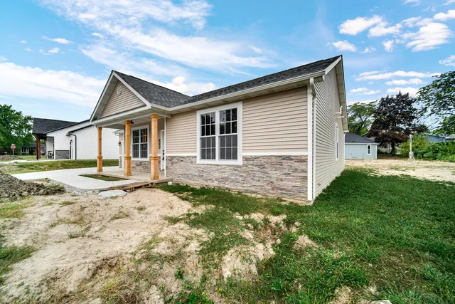 a backyard of a house with table and chairs