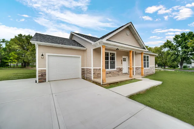 a view of backyard with a garden and trees