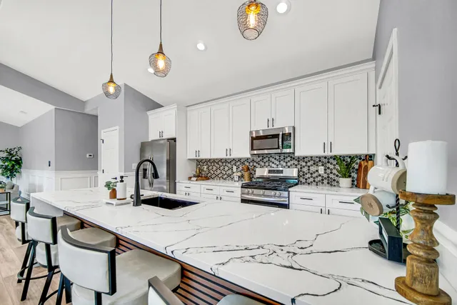 a kitchen with a sink appliances and cabinets