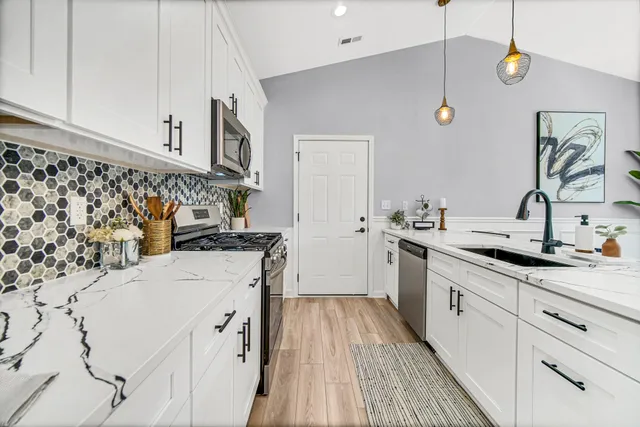 a kitchen with a sink stove and refrigerator