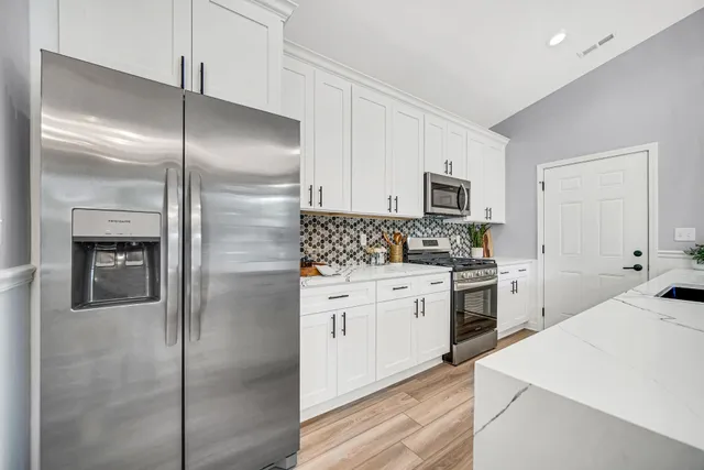 a kitchen with a refrigerator stove and microwave