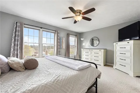 a bedroom with a large bed and a window