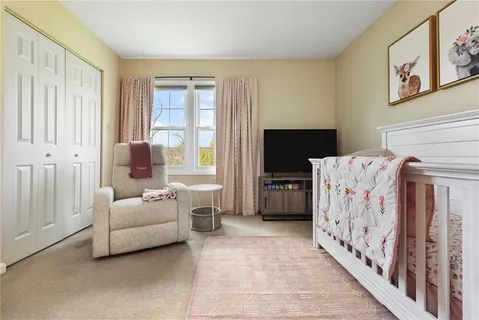 a bedroom with furniture and large window