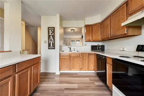 a kitchen with stainless steel appliances granite countertop a sink and cabinets