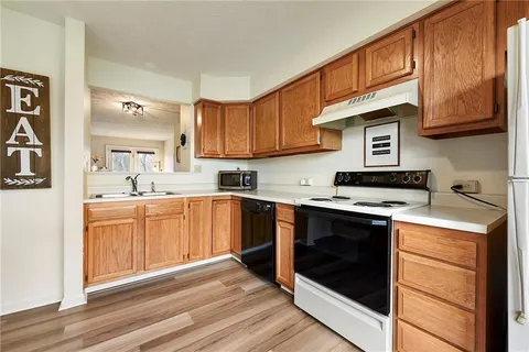 a kitchen with stainless steel appliances granite countertop a stove and a sink