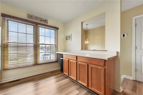 a bathroom with a sink and a large mirror next to a window
