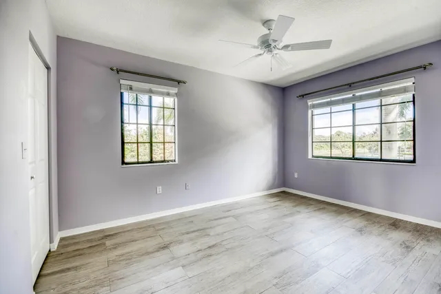 a bathroom with a granite countertop sink mirror and shower
