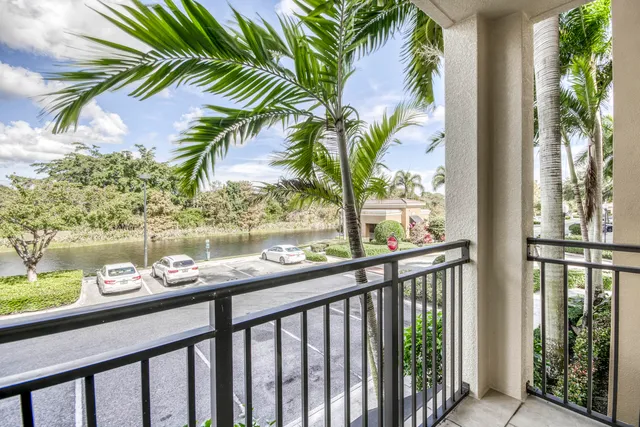 a view of an empty room and chandelier fan