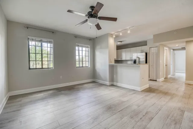 a kitchen with a refrigerator sink and cabinets