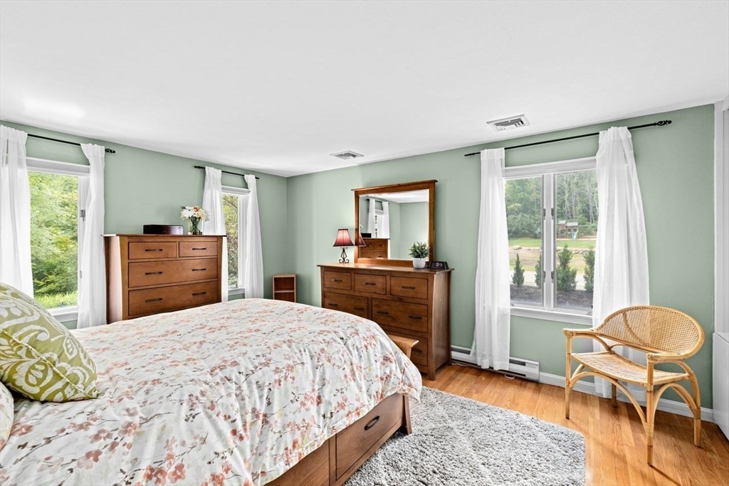 131 Cross Street Norwell, MA 02061 - Photo 14 of 41 a bedroom with a bed and chair