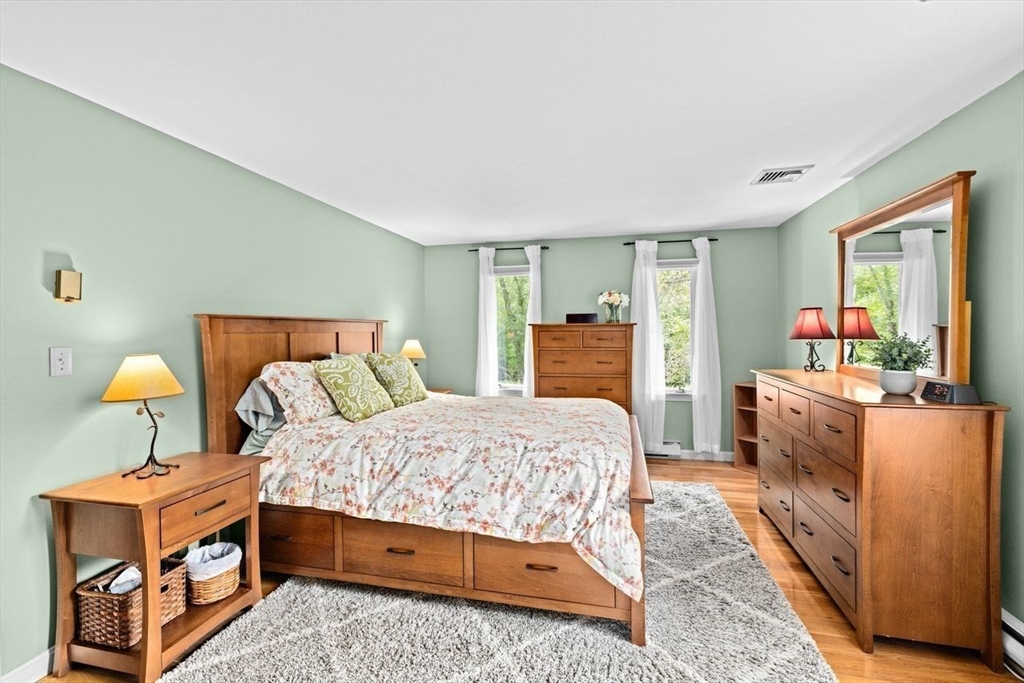 131 Cross Street Norwell, MA 02061 - Photo 15 of 41 a bedroom with a bed and a dresser in it