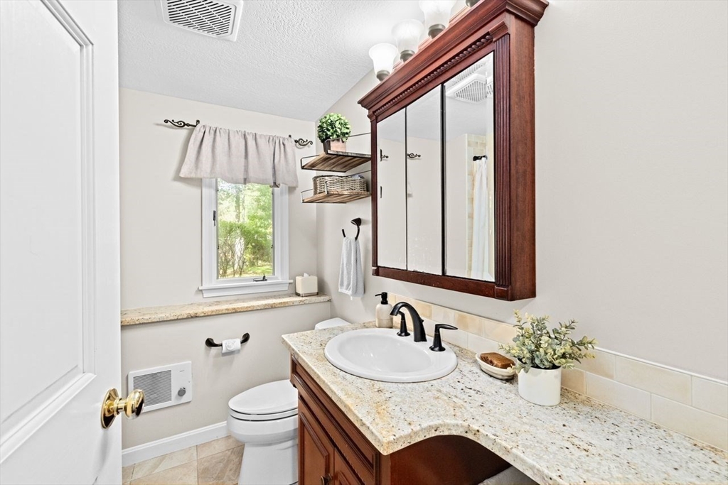 131 Cross Street Norwell, MA 02061 - Photo 23 of 41 a bathroom with a granite countertop sink and a mirror