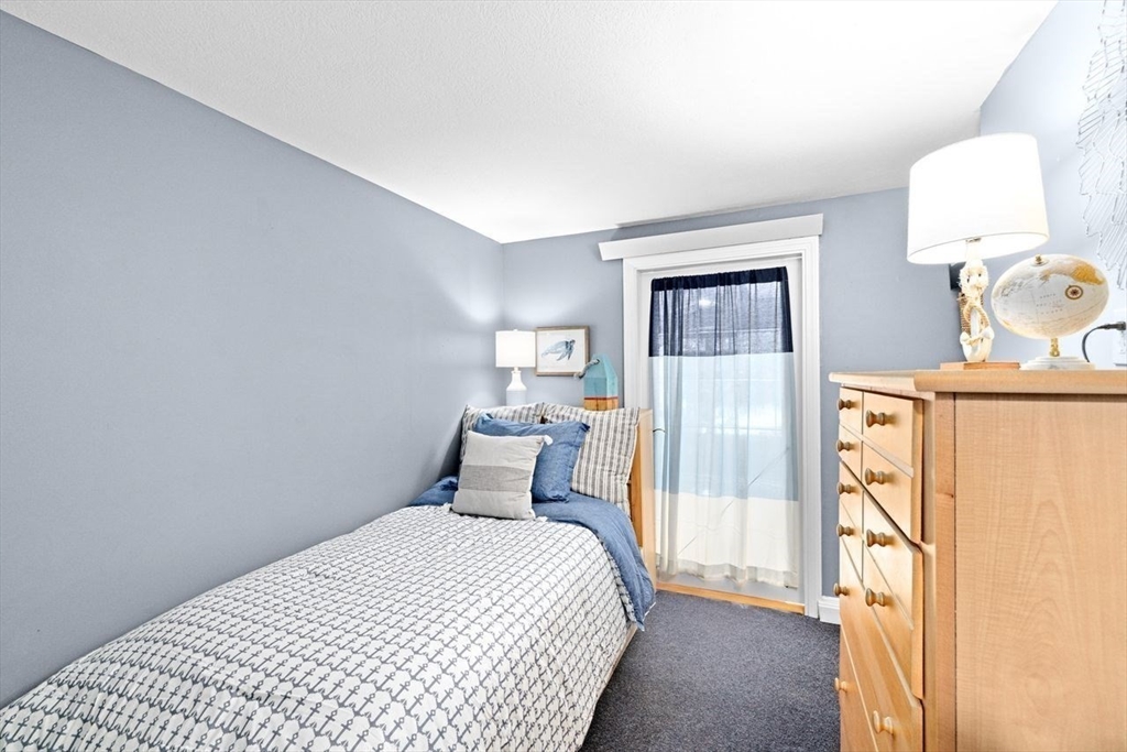 131 Cross Street Norwell, MA 02061 - Photo 25 of 41 a bedroom with a bed and a table in it