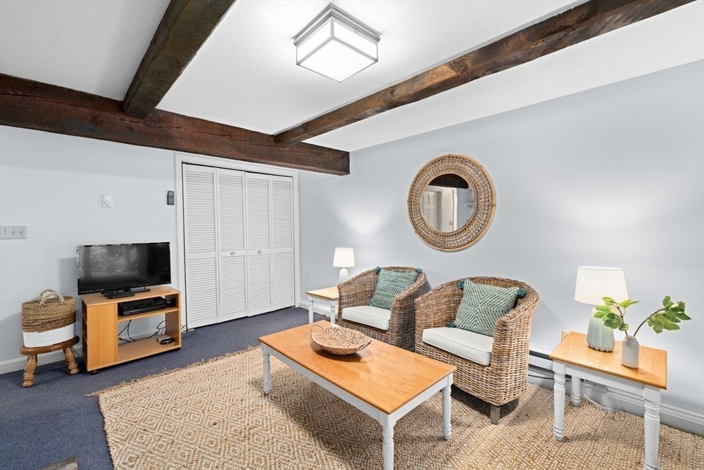 131 Cross Street Norwell, MA 02061 - Photo 27 of 41 a living room with furniture and a flat screen tv