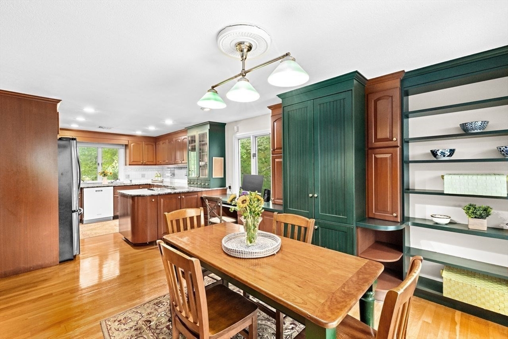 131 Cross Street Norwell, MA 02061 - Photo 6 of 41 a view of a dining room with furniture a kitchen and wooden floor
