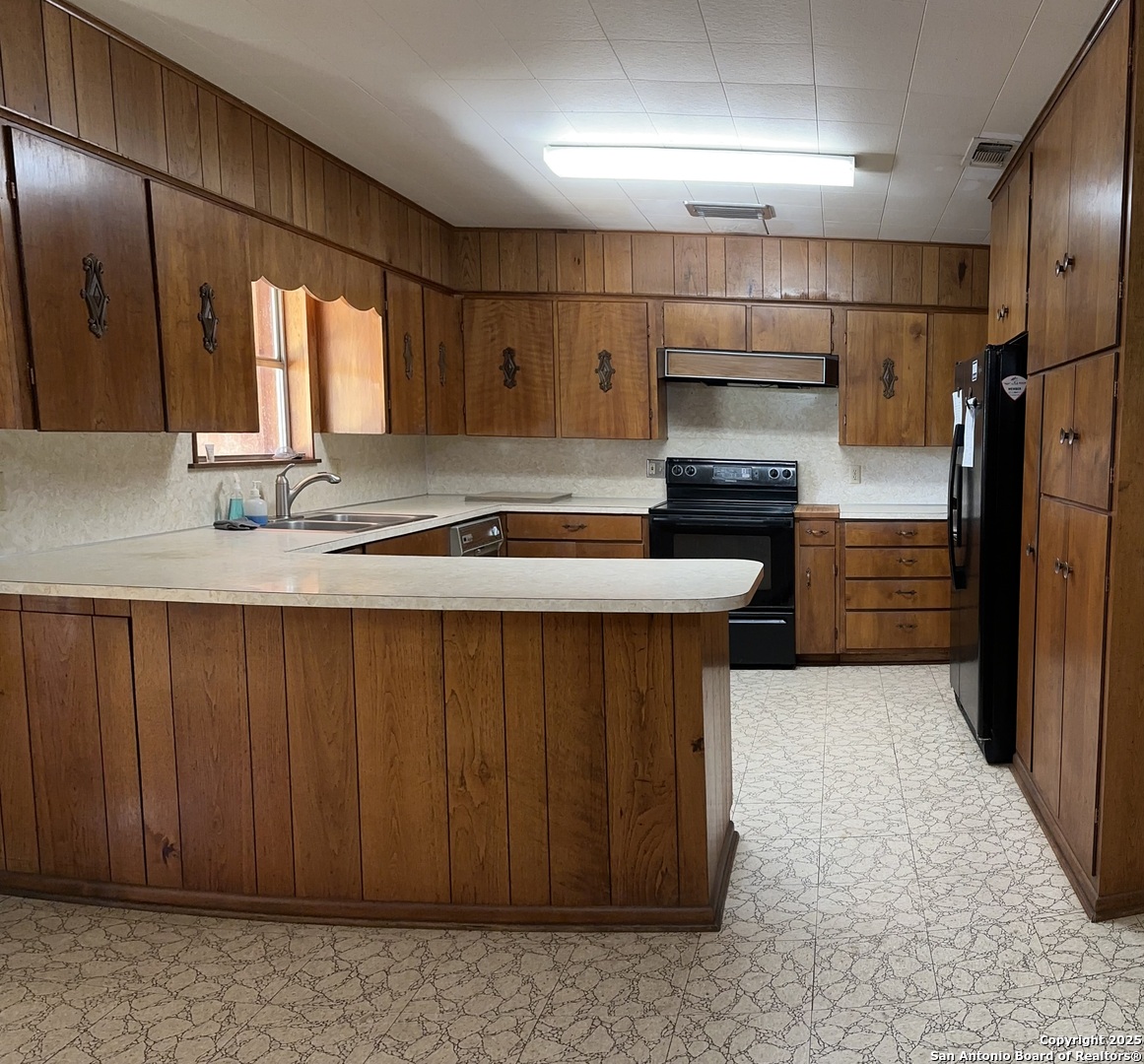 779 Main Street Utopia, TX 78884 - Photo 12 of 22 a kitchen with stainless steel appliances a sink and a refrigerator