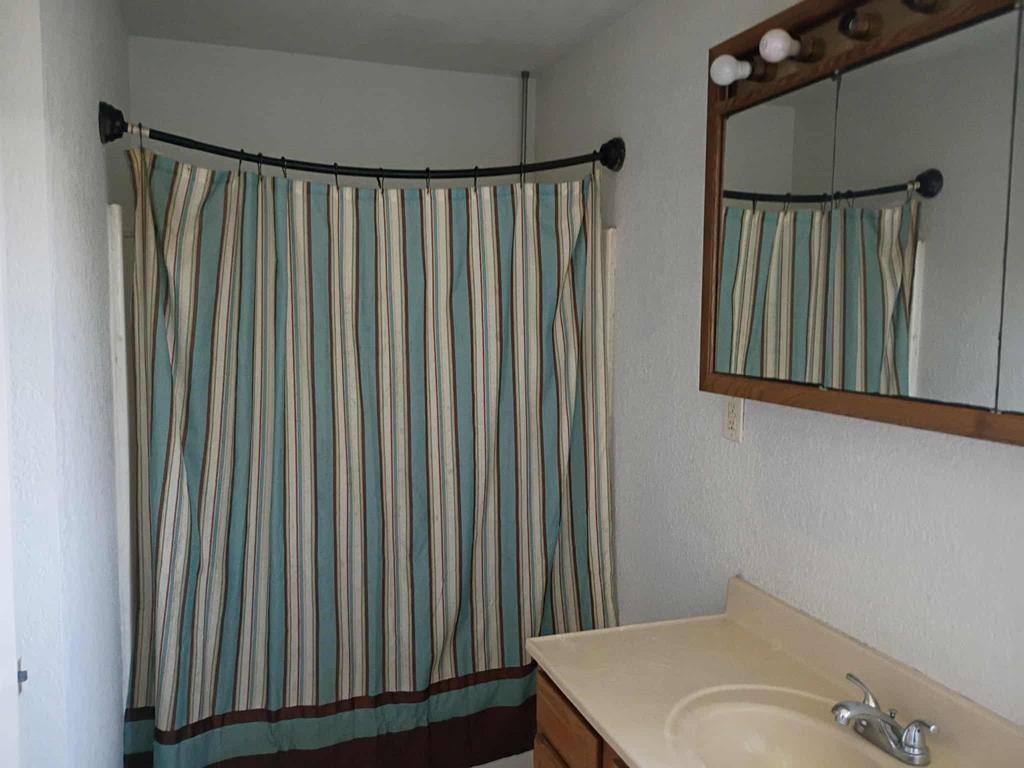 634 East Eubank Street Mabank, TX 75147 - Photo 20 of 40 a bathroom with a sink and a mirror