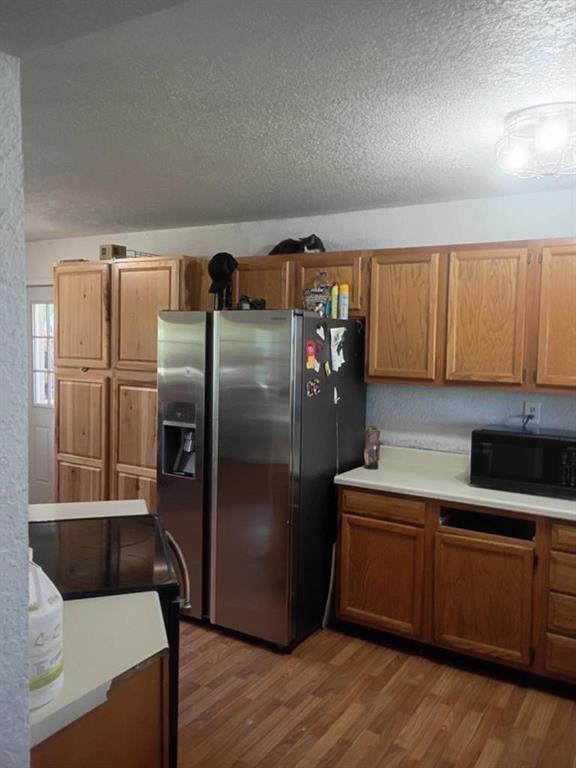 634 East Eubank Street Mabank, TX 75147 - Photo 25 of 40 a kitchen with stainless steel appliances a refrigerator a sink a stove and cabinets