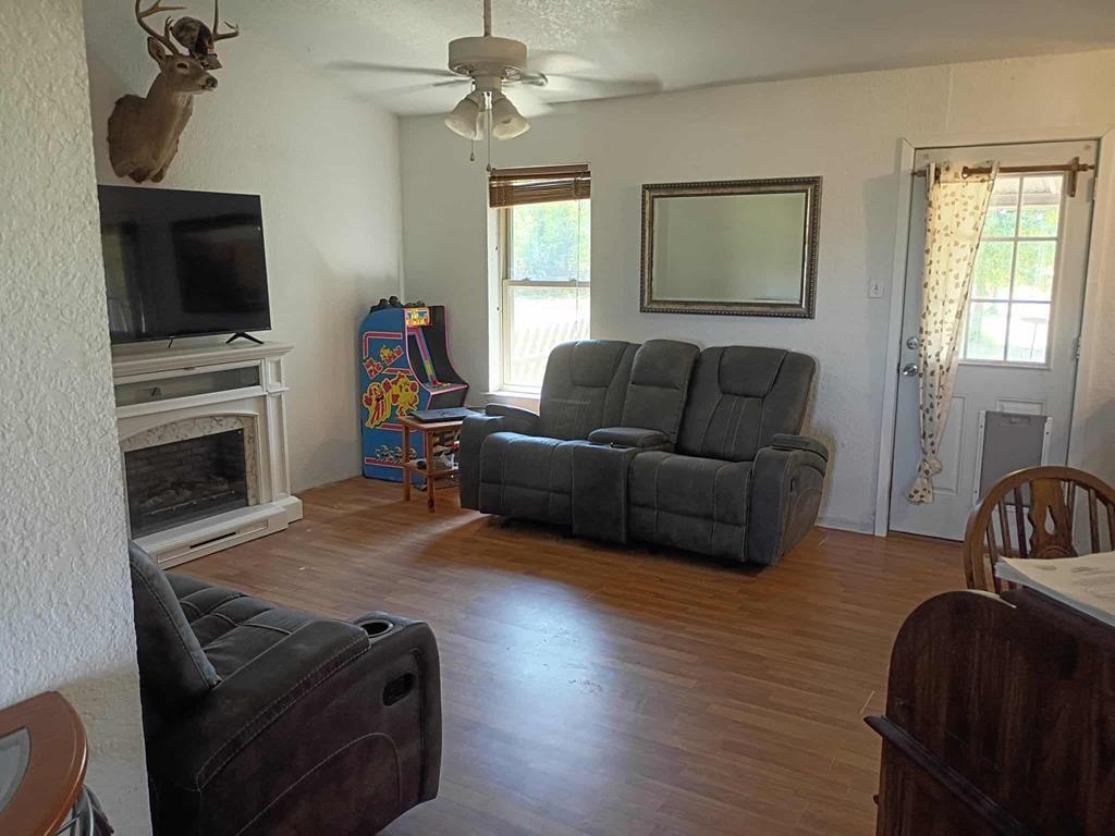 634 East Eubank Street Mabank, TX 75147 - Photo 26 of 40 a living room with furniture and a flat screen tv