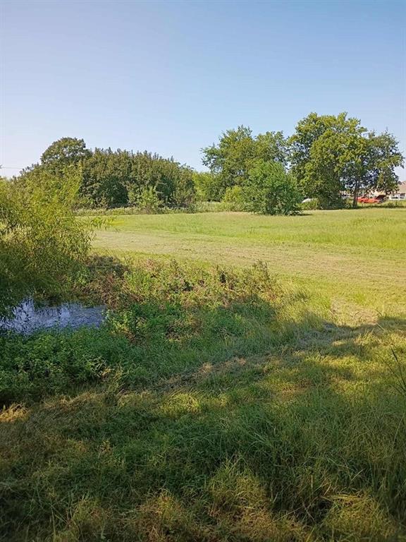 634 East Eubank Street Mabank, TX 75147 - Photo 37 of 40 a view of a lake with a yard