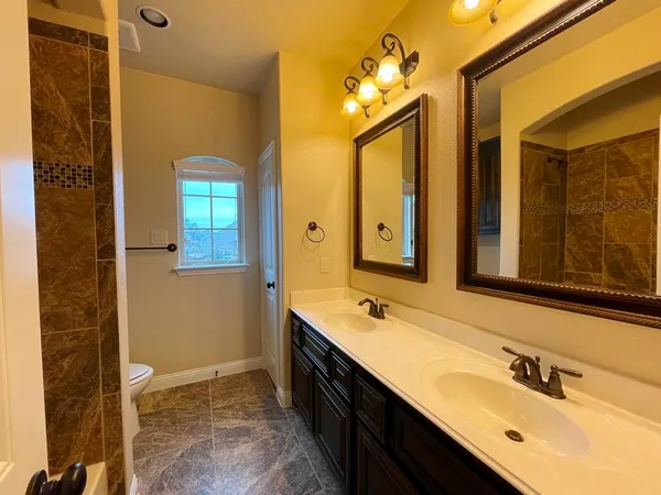 a bathroom with a tub sink and mirror