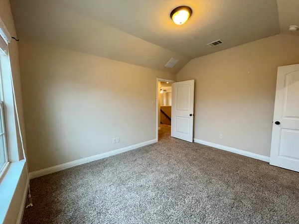 a bedroom with a bed and potted plant