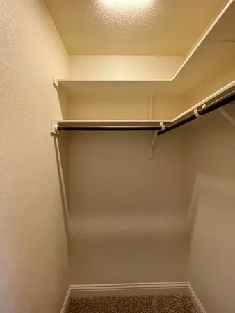 a view of an empty room and closet