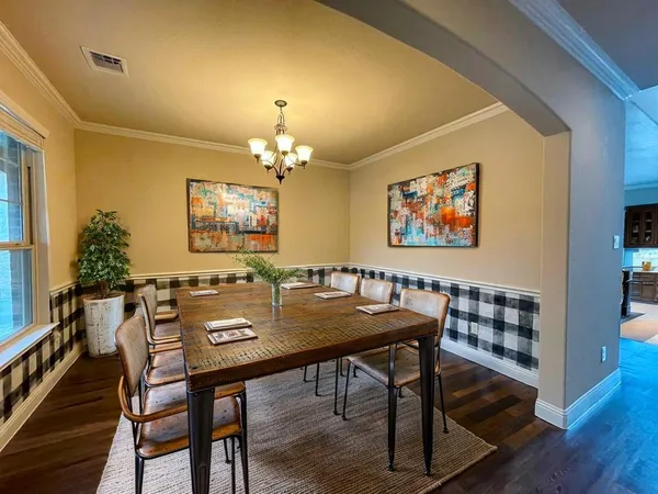 a view of a dining room with furniture and wooden floor