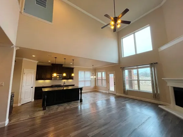 a view of a livingroom with a kitchen and a stove wooden floor