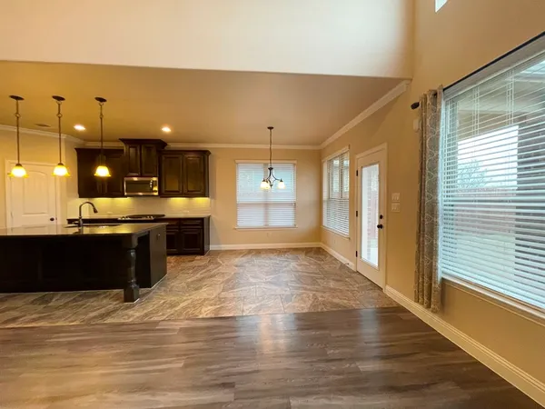 a kitchen with stainless steel appliances kitchen island granite countertop a sink and cabinets