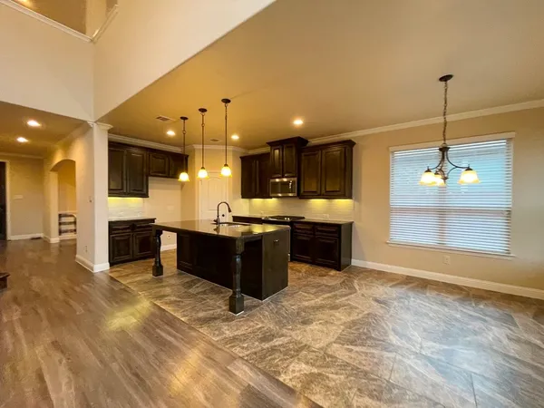 a view of a kitchen with furniture and a ceiling fan
