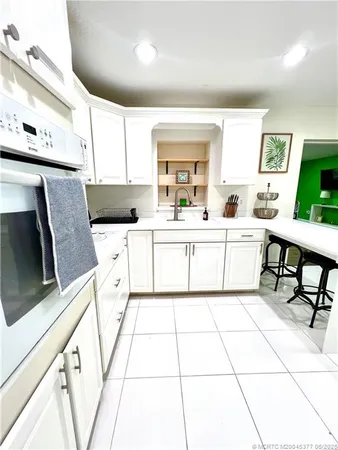 a kitchen with a sink a stove cabinets and counter space