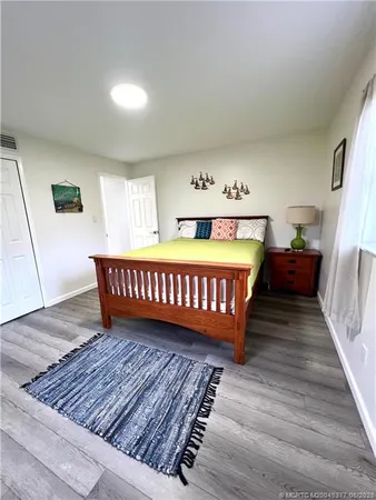 a bedroom with two beds and a desk
