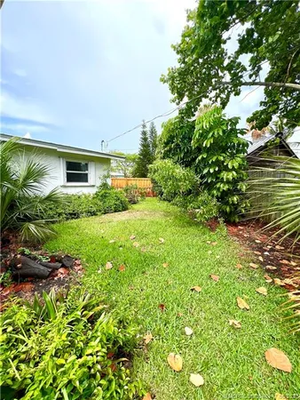 a view of backyard of house with green space