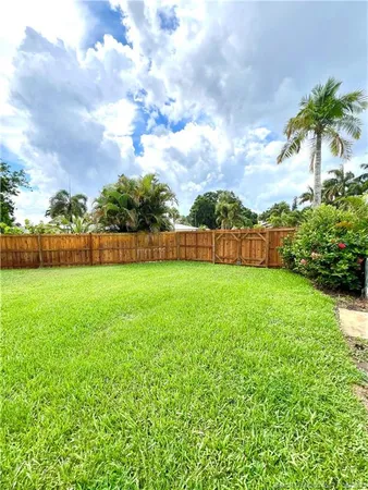 a view of yard with swimming pool and green space