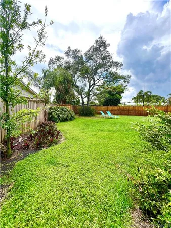 a view of a garden with a building in the background