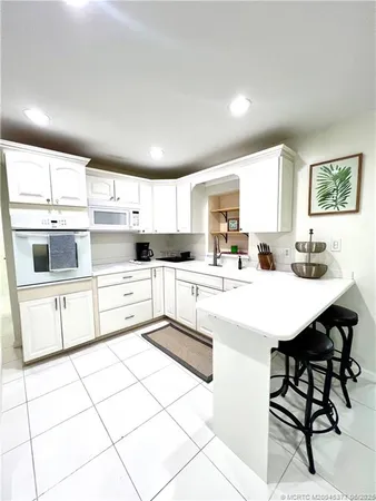 a kitchen with stainless steel appliances kitchen island granite countertop a sink and cabinets