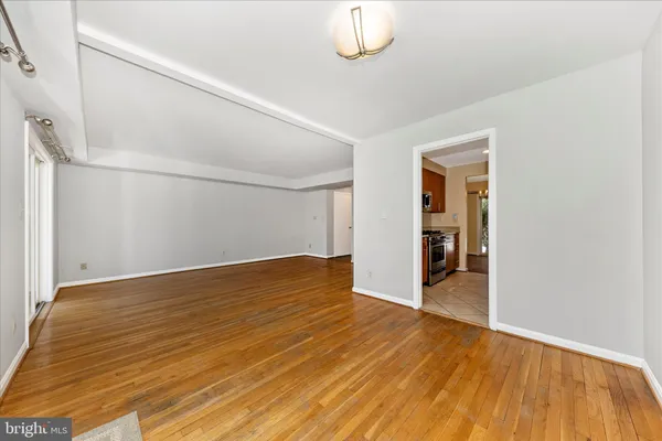 a view of empty room with wooden floor