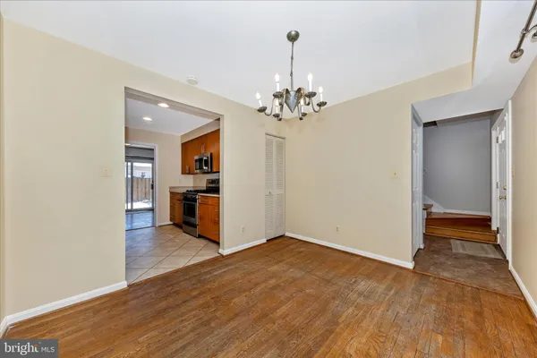 a view of a kitchen with wooden floor and a kitchen