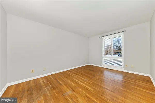 a view of a big room with wooden floor and a carpet