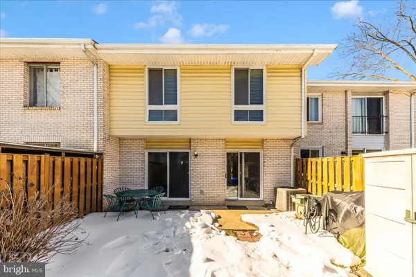 a view of backyard with table and chairs and wooden fence