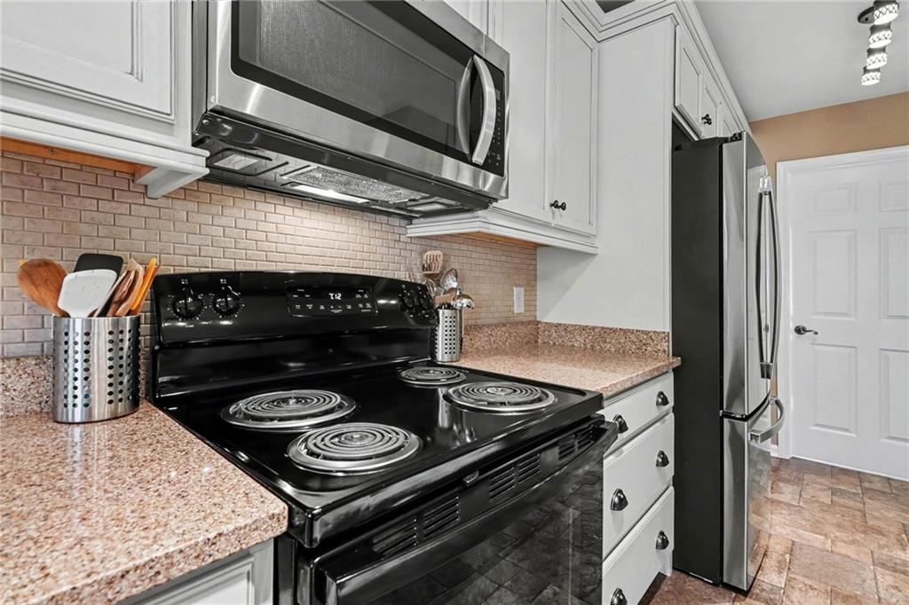 65 Indian Hills Drive Rydal, GA 30171 - Photo 11 of 32 a kitchen with a stove and a microwave