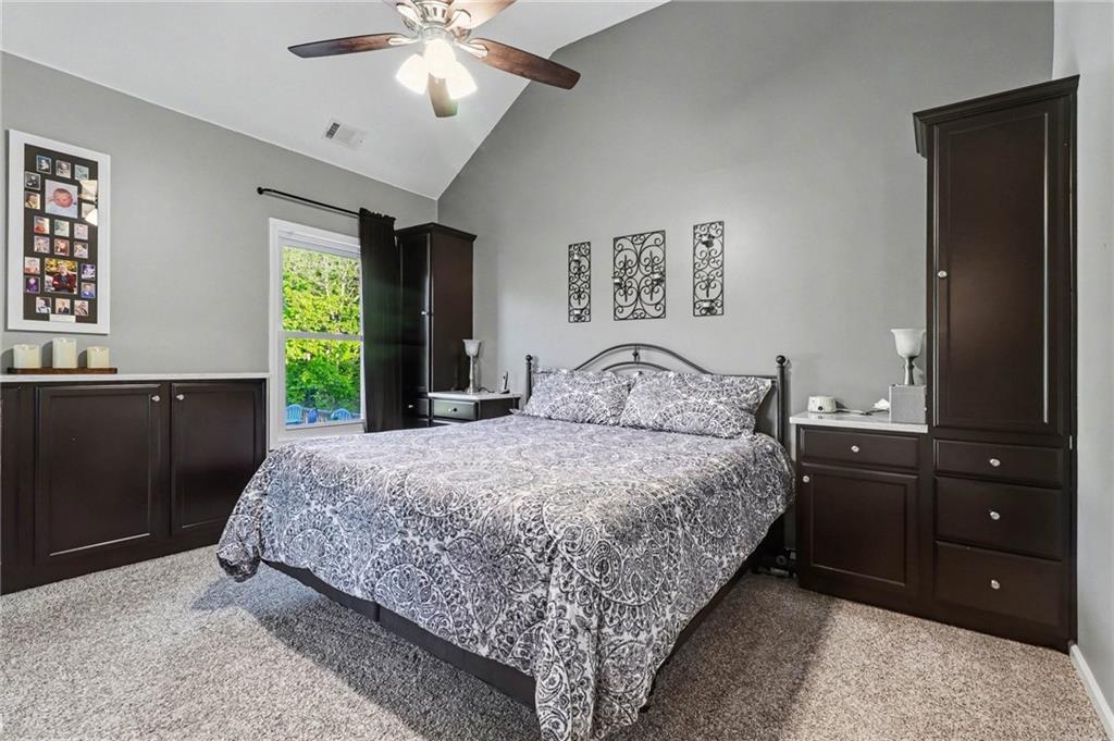 65 Indian Hills Drive Rydal, GA 30171 - Photo 13 of 32 a bedroom with a large bed and a dresser
