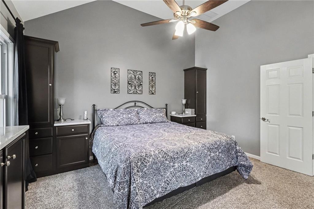 65 Indian Hills Drive Rydal, GA 30171 - Photo 14 of 32 a bedroom with a bed and a chandelier