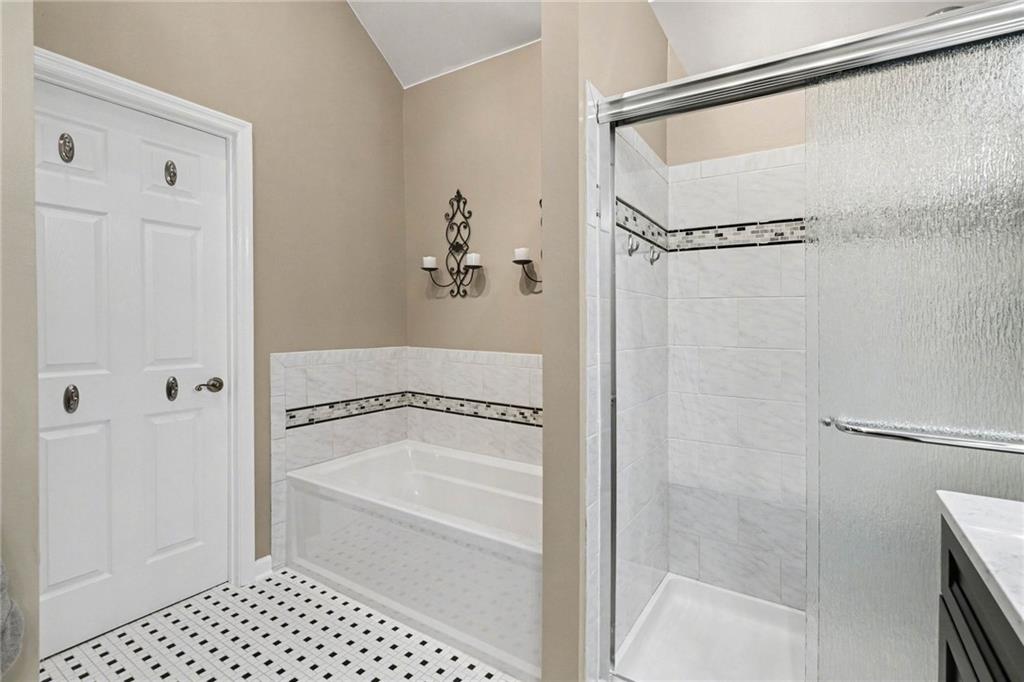 65 Indian Hills Drive Rydal, GA 30171 - Photo 16 of 32 a bathroom with a bathtub and a shower